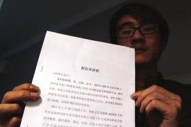2月25日晚，山西平定县，死者儿子陈顺攀拿着控告申诉状。图/记者邵骁歆