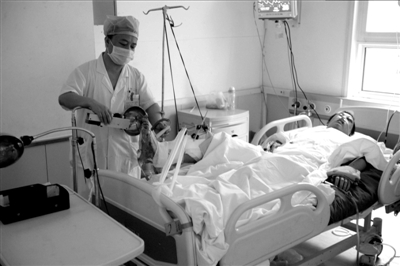 因救下自杀者而下肢重伤的李博亚在重症监护室内接受救治。本报记者欧阳晓菲摄