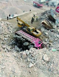 自卸车滚落20米司机困车内