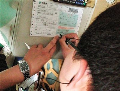 快递员在装着菜刀的包裹单上填写单据。